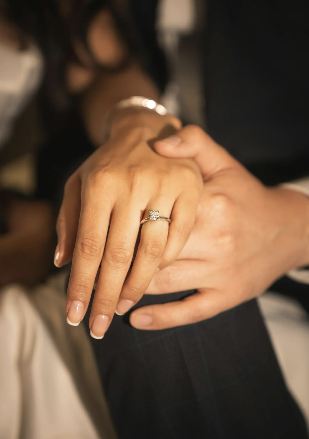 wedding ring and couple holding hands.